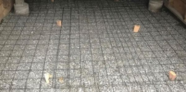 ABBA Construction Group trap stone, and rebar installed for concrete floor installation in basement 