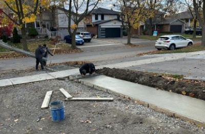 abba  construction group workers pouring concrete for sidewalk