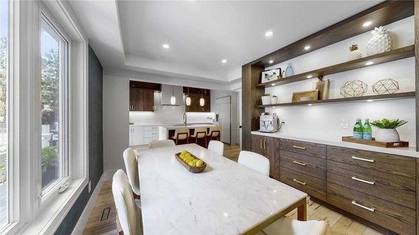 DINING AREA WITH BUILT IN BUFFET AND OPEN SHELVING THAT MATCHES KITCHEN CABINETS INSTALLED IN LINWOO