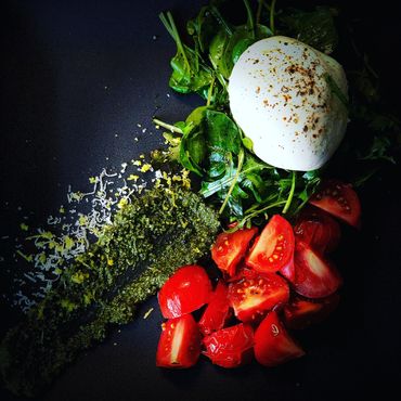 Burrata mozzarella, pesto, grape tomatoes, dressed spinach