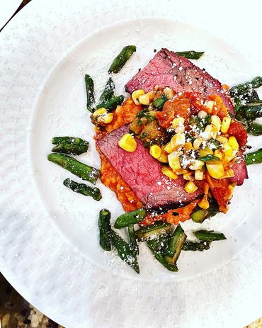 Flank steak, roasted tomato corn salsa, guajillo grits, charred asparagus