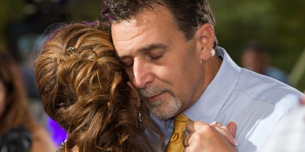 Husband and Wife Dancing together feeling the music at heart