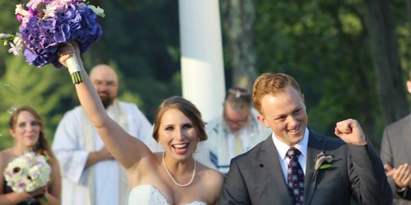 Bride and Groom coming down the aisle after saying I do in celebration