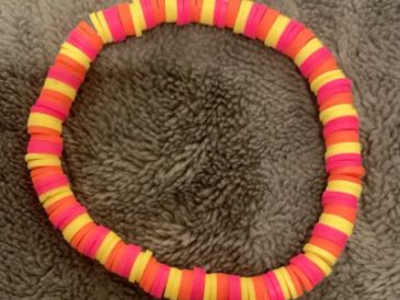 A colorful bracelet with pink, orange, and yellow beads.