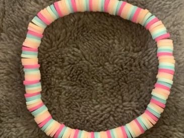 Colorful candy bracelet on a brown surface.