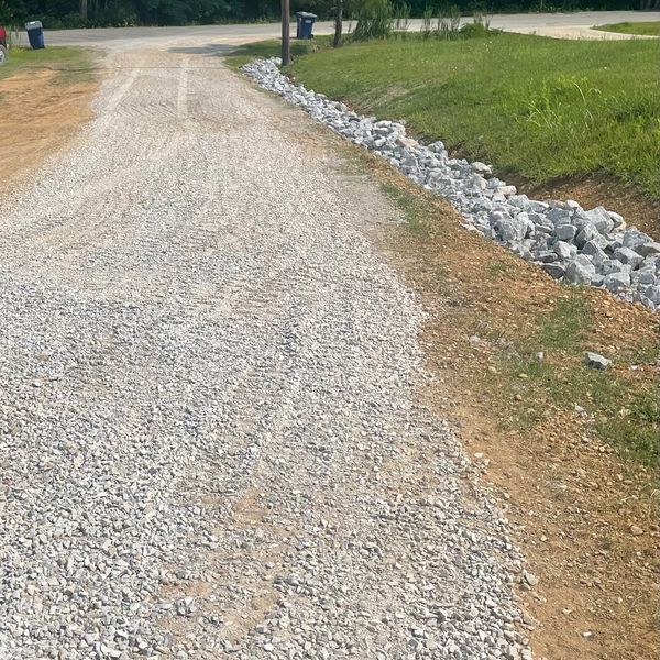 Resurfaced driveway and cleaned ditch due to severe damage from drainage installed riprap