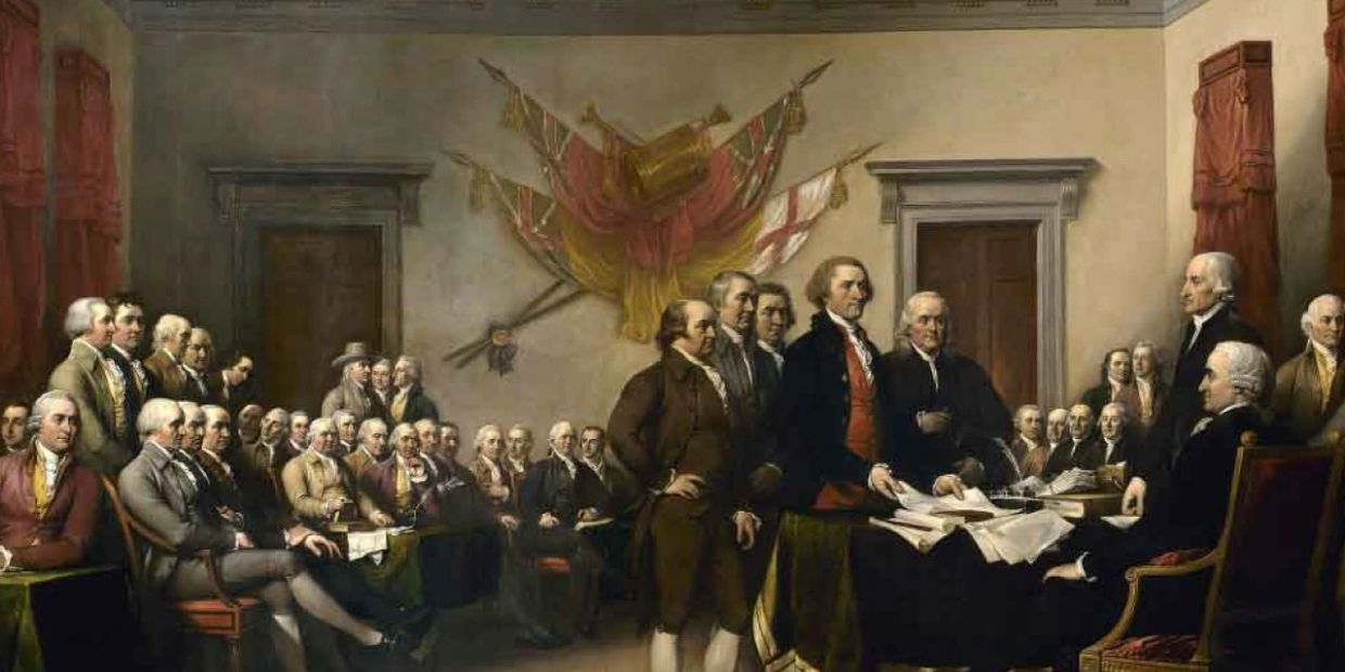 Founding Fathers presenting a document in a historic room.