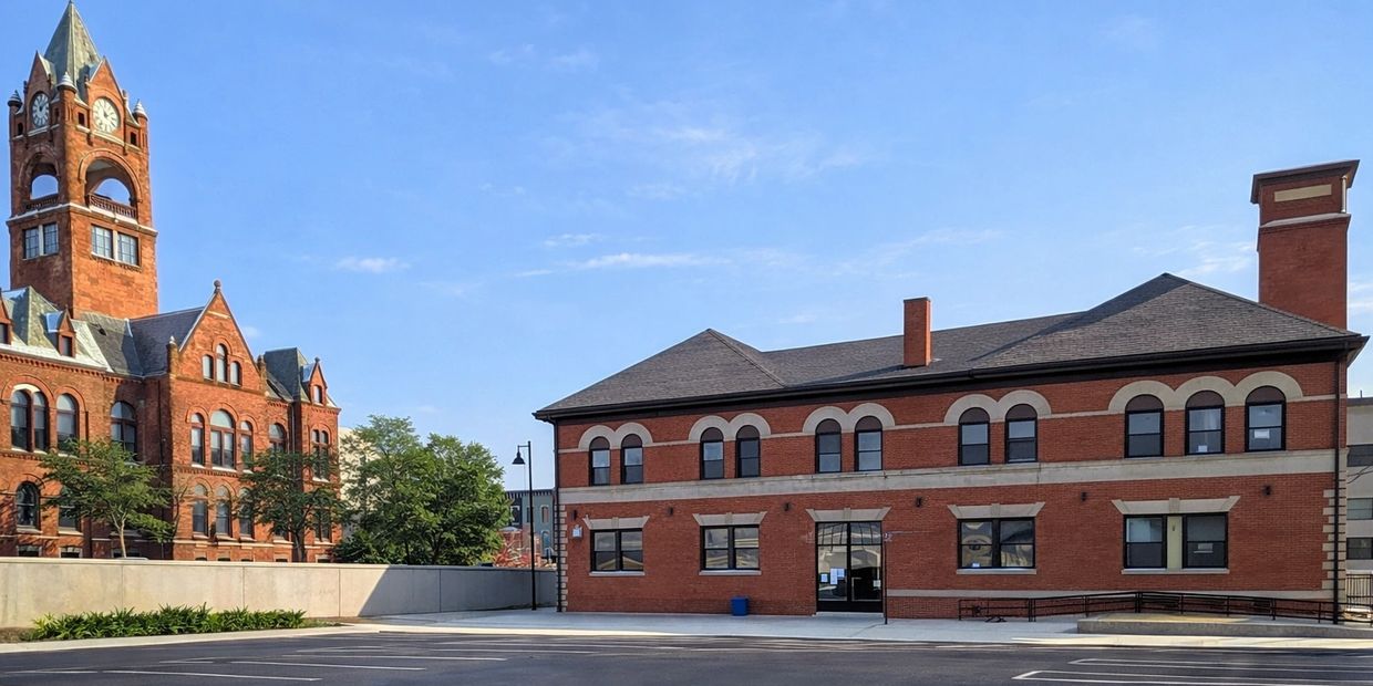 Historic red brick buildings under a clear blue sky.