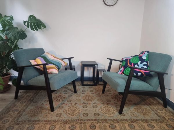 Cosy therapy room with bright cushions in counselling room in Saffron Walden