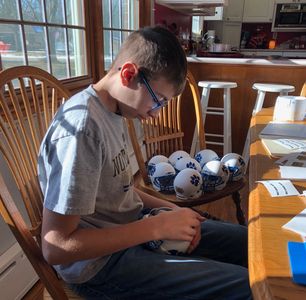 Jack working on mini football helmets.
