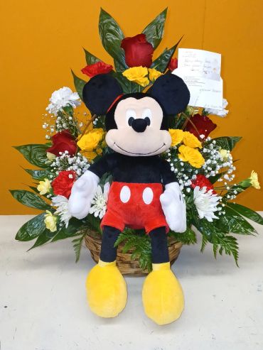 Mickey Mouse plush with a colorful flower arrangement.
