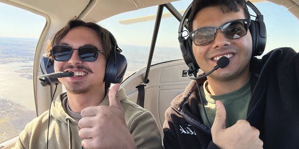 two people flying in an airplane