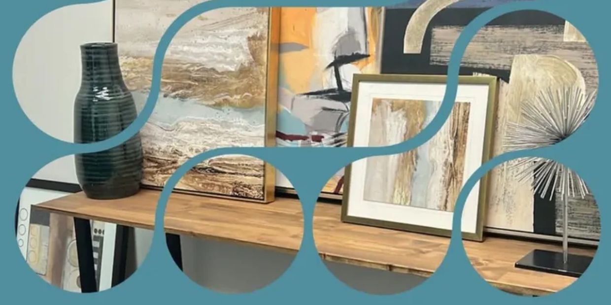 Artistic decor with vases and abstract paintings on a wooden shelf.