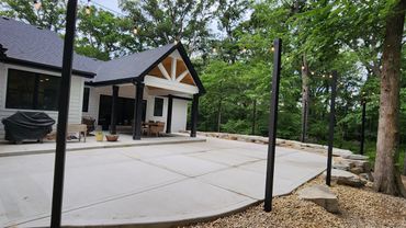 Concrete patio with natural stone retaining wall in Joliet, Illinois 