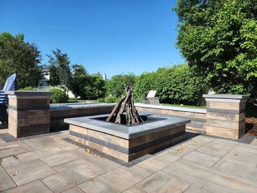 Bring your family and friends together around a Unilock U-Cara Firepit and seating wall!