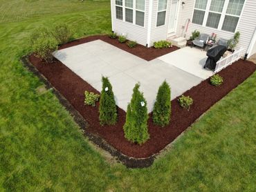 Concrete patio in Plainfield, IL with landscaping 