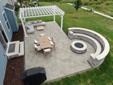 Paver patio with seating Bench and gaslight firpit.  Unilock