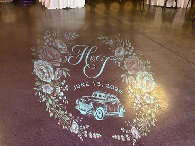 Decorative floor projection with floral wreath and vintage truck.