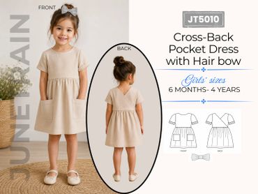 Young girl modeling a beige cross-back pocket dress with a hair bow for girls aged 6 months to 4 years.