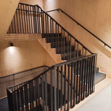 Blackened steel balustrade and handrails, and steel staircase.