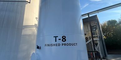 Large industrial tank labeled 'T-8 Finished Product' outdoors.