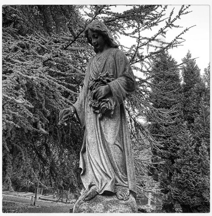 A black & white image of a classical graveyard statue from Worthing Cemetery