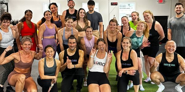 Group of diverse people posing happily after a workout session.