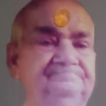 Portrait of a man with a yellow mark on his forehead.