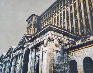 Historic classical building with columns under gray sky.