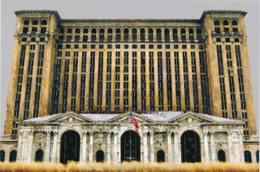 Abandoned historic train station building with an American flag.