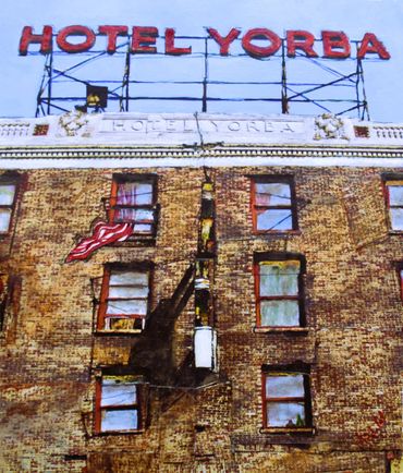 Exterior view of Hotel Yoreba with American flag and red signage.