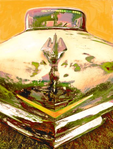 Close-up of a rusty vintage car hood and emblem.