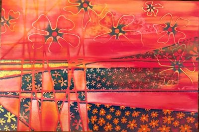 Vibrant abstract painting featuring floral patterns in red and orange hues.