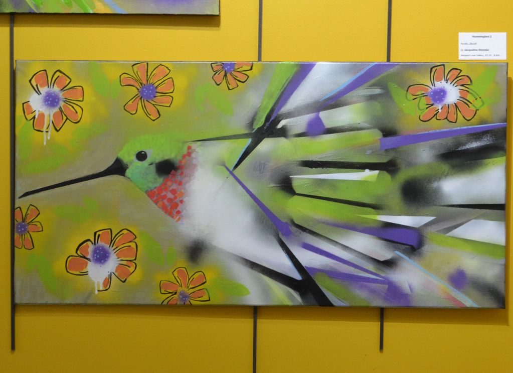 Colorful hummingbird painting with abstract flowers on yellow background.