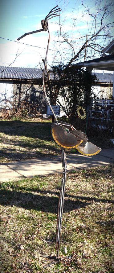 Metal sculpture of a bird made from recycled tools and machinery parts.