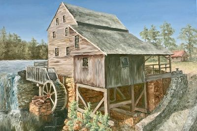 A rustic watermill with a large wheel beside a flowing river.