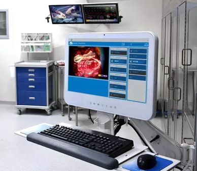 Medical monitor displaying surgical images and controls in an operating room.