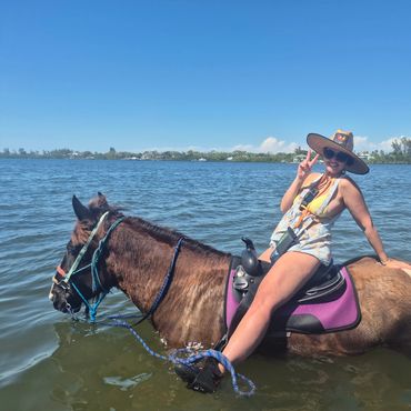 Riding horses in the water in on Anna Maria Florida.