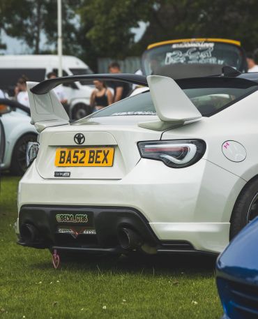 Rear view of a white sports car with a large spoiler.