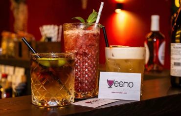 Three cocktails on a bar counter.