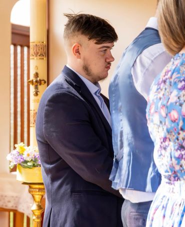 Man in a suit at a formal indoor event.