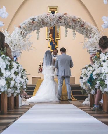 Bride and groom at altar during wedding ceremony.