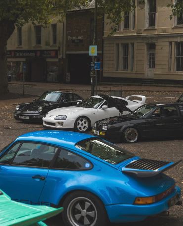 A group of classic sports cars parked together.