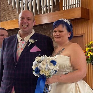 Bride and groom smiling at their wedding.