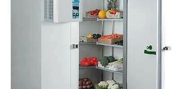 Open fridge filled with fresh fruits and vegetables.