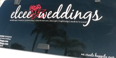 Logo for Elcee Weddings on a glass surface.
