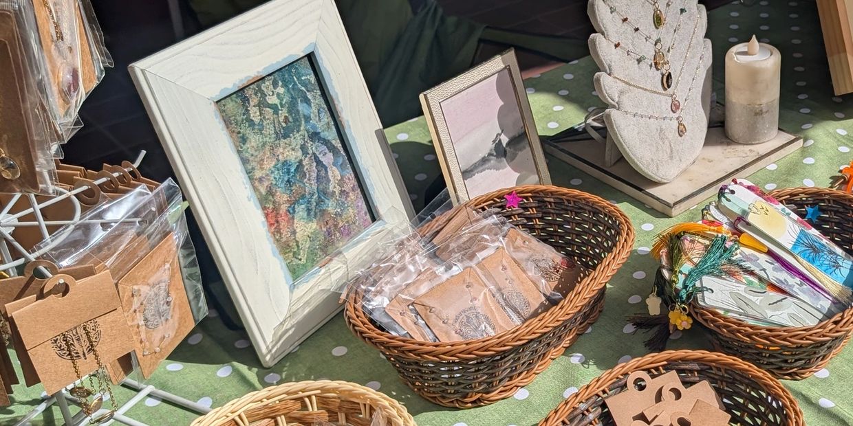 Display of handmade jewelry and bookmarks at a market stall.