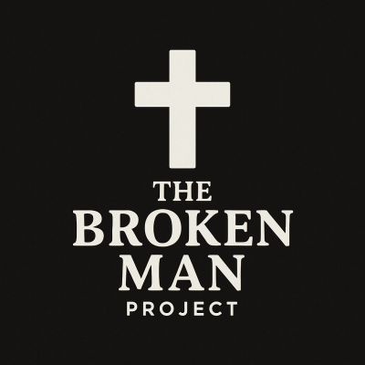 Logo of The Broken Man Project with white cross on black background.