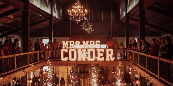 Wedding with marquee lights and fire sparklers. 