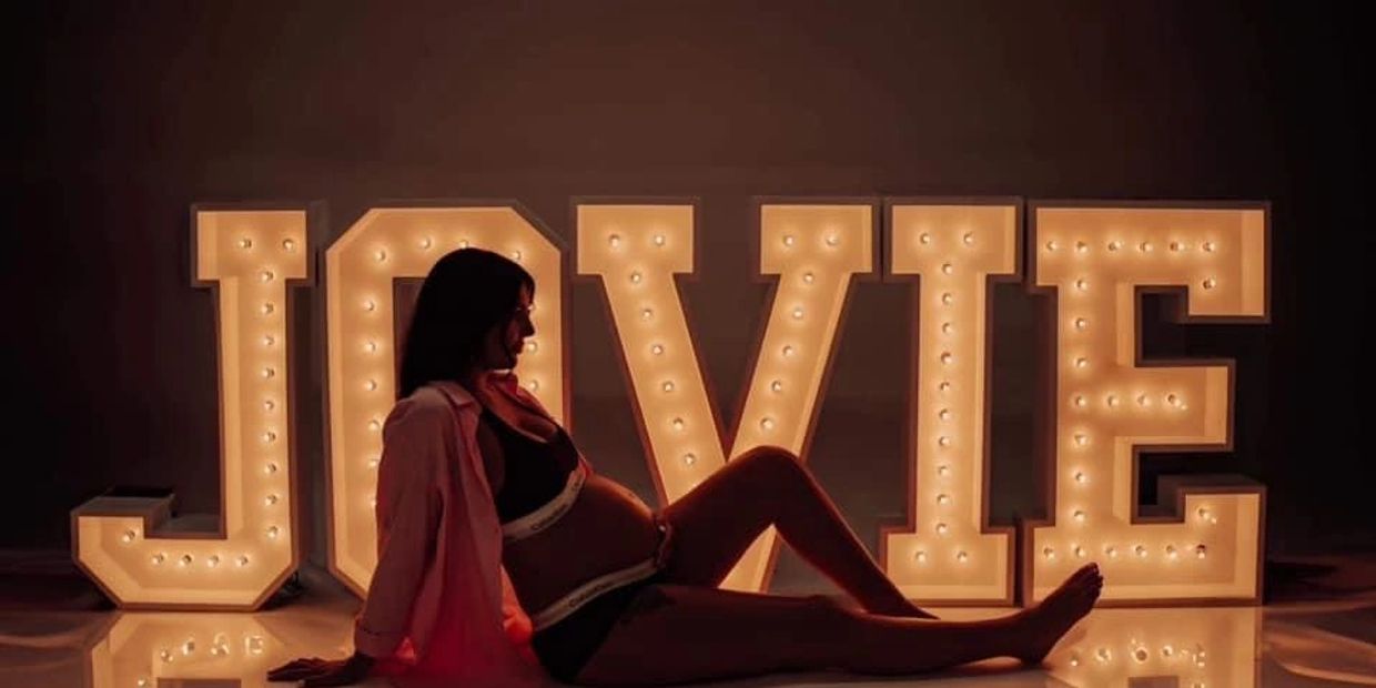 Baby announcement with name of baby in Marquee Letter lights. 